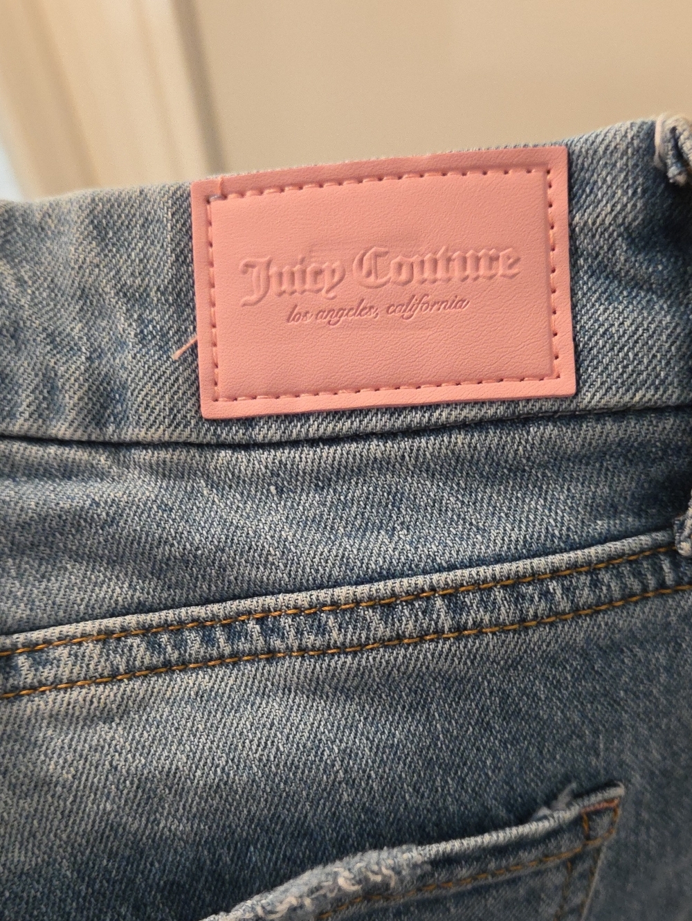 Light-wash denim shorts by Juicy Couture featuring a classic mid-rise - Picture 4 of 5